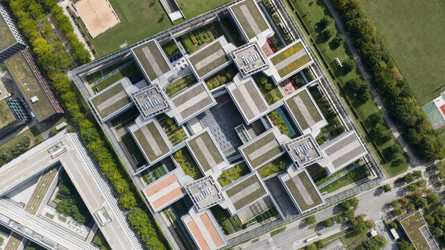 Unterfohring, Germany - 12 September 2026: Aerial view of Allianz Commercial headquarters featuring a modern complex with interconnected buildings, green rooftop gardens, and central courtyards.