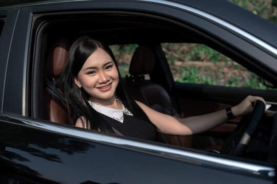 Happy young woman in a car