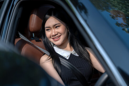 Happy young woman in a car