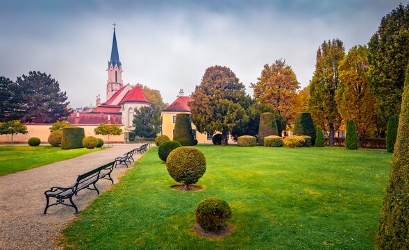 Attractive autumn view of Hietzing Catholic Church (Maria Geburt). Marvelous morning cityscape of Vienna, capital of Austria, Europe. Calm scene of empty public city park.