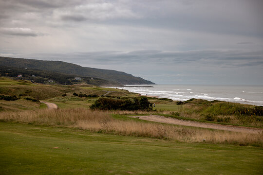 Inverness, Canada - September 18, 2026: Rolling fairways and bunkers at Cabot Links overlook the Gulf of St. Lawrence beneath a cloudy sky.