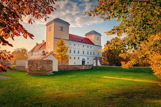 Autumn sunrise of Wolkersdorf Castle on the shore of castle pond. Attractive morning cityscape of Wolkersdorf town, town in the district of Mistelbach in the state of Lower Austria.