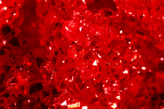 Amethyst red crystals. Gems. Mineral crystals in the natural environment. Texture of precious and semiprecious stones. Seamless background with copy space colored shiny surface of precious stones.