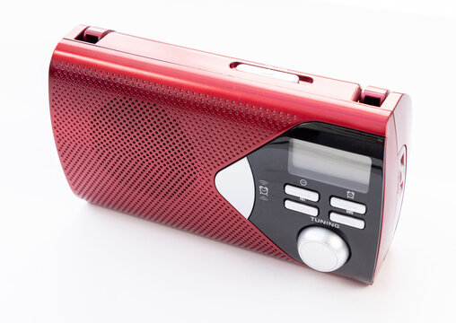 Compact red portable radio receiver isolated on white background