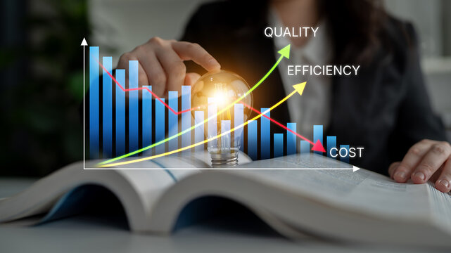 Businesswoman Analyzing Data with Graphs Representing Quality, Efficiency, and Cost on Open Book in Modern Office Environment. Bitwise.