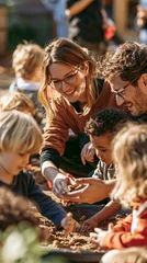 a family of four, a man, a woman, and two young children, engaged in a playful activity. The woman, wearing glasses and a brown shirt, smiles as she interacts with the children. The man. © rabbit75_fot