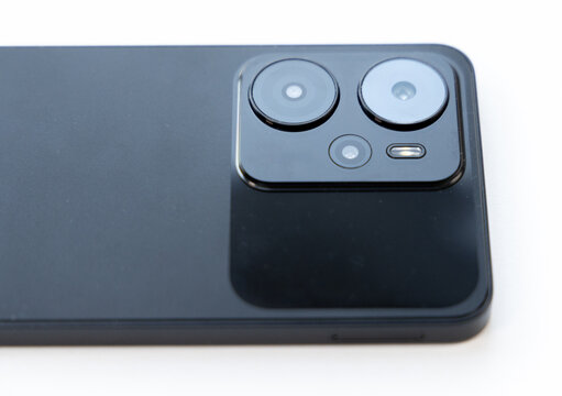 Close up view of smartphone multiple cameras on white background