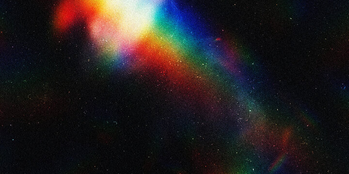 Abstract rainbow light prism effect on a dark textured background