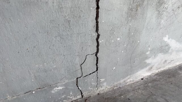 Abstract macro texture of deep cracked cement concrete wall background