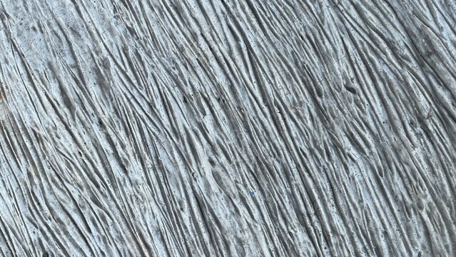Detailed industrial grey concrete surface with dense linear patterns
