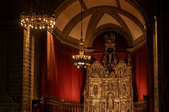 Ornate altarpiece and glowing chandeliers in valladolid church