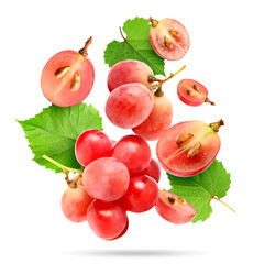 Obraz premium Fresh pink grapes and green leaves falling against white background