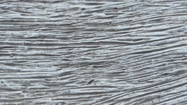 Abstract macro texture of wavy raw cement concrete background