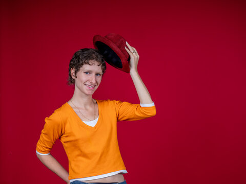 Young woman smiling tipping red hat portrait