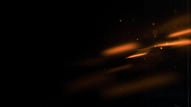 Abstract orange light streaks on black background with bokeh