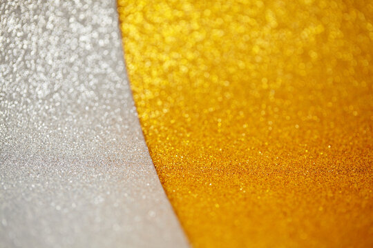 Reflective Shimmer On Curved Surfaces. Luxurious Metallic Tones With Sparkling Granular Details. Detailed View Of Metallic Gold And Silver Shades Featuring Glittery Textures And Smooth Curves