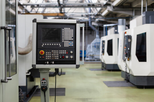 Control panel of modern CNC milling machine in industrial workshop. Advanced manufacturing technology and automation in modern industry.