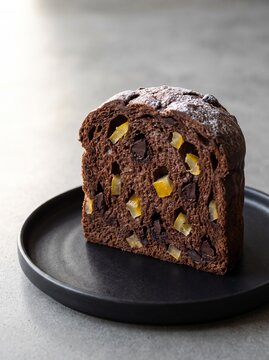 Minimalist Dark Chocolate Panettone with Japanese Yuzu and Sorrento Lemon Peel on Black Plate