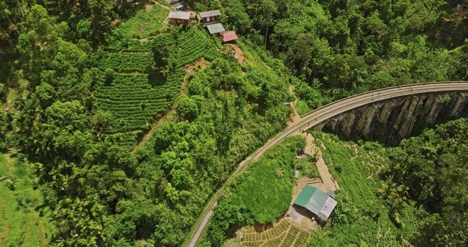 Ella Sri Lanka Aerial v30 birds eye view drone flyover along Nine Arches Bridge spanning the mountain valley, surrounded by a hilly landscape and lush greenery - Shot with Mavic 3 Cine - April 2023