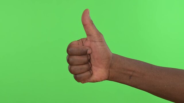 Thumbs up gesture isolated on green screen background