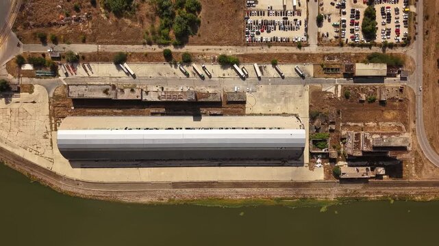 Top down drone view of abandoned oval factory roof