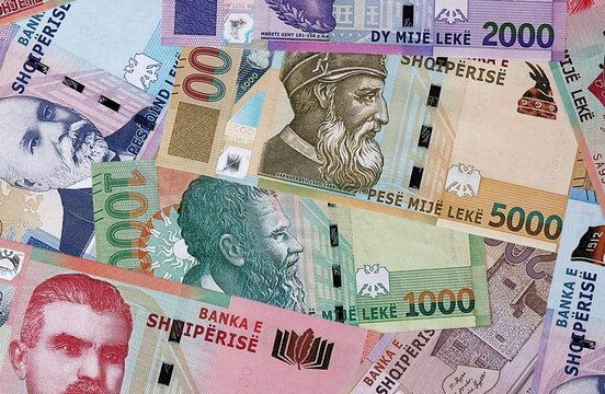 Albanian lek money bills in pile on table. Albania ALL currency banknotes background