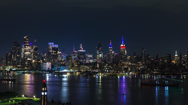 In USA 250 years celebration, the New York City skyline rises in a dazzling wall of light beyond the dark waters of the Hudson River