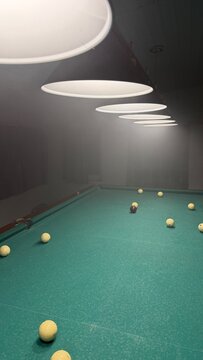 A perspective shot looking down a green billiards table with white balls illuminated by a sequence of overhead lamps in a smoky haze.