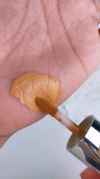 Close up of palm being applied with cushion makeup. Foundation swatch concept, beauty product test for daily makeup routine.