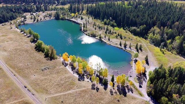 Quarry Lake aerial landscape with autumn yellow trees and majestic Canadian Rockies. Canmore, Alberta, Canada.