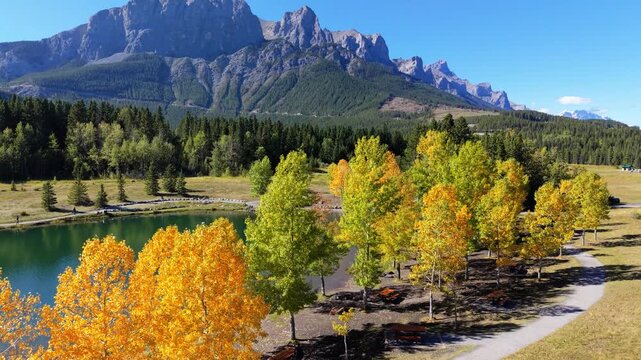 Quarry Lake aerial landscape with autumn yellow trees and majestic Canadian Rockies. Canmore, Alberta, Canada.