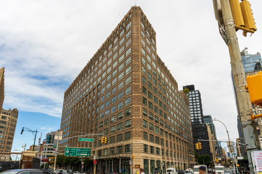 New York, NY - US - Sep 25, 2026 : One Hudson Square, the historic Holland Plaza Building at 75 Varick Street, rises above Canal Street with a massive brick facade and rows of industrial windows.