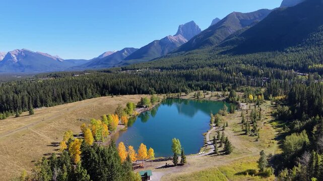 Quarry Lake aerial landscape with autumn yellow trees and majestic Canadian Rockies. Canmore, Alberta, Canada.