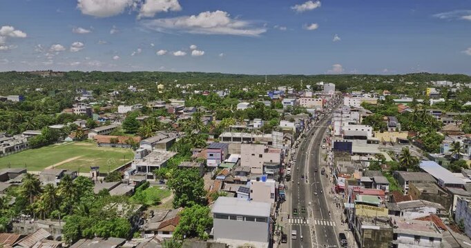Matara Sri Lanka Aerial v6 drone flyover along B535 Nilwala Bypass from Nupe towards Kadeweediya town center capturing local traffic and townscape on a sunny day - Shot with Mavic 3 Cine - April 2023