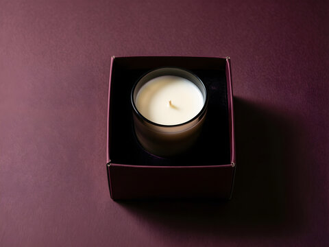 Plain hand-poured candle in a smoked-glass vessel inside an open rigid box for premium winter gifting, luxury retail and holiday packaging campaign