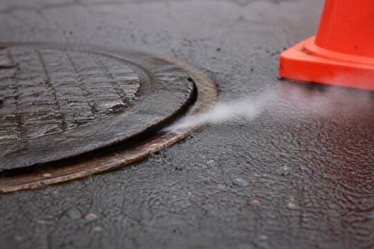 Sanitary sewer smoke testing - test vapor escaping through a defective manhole frame