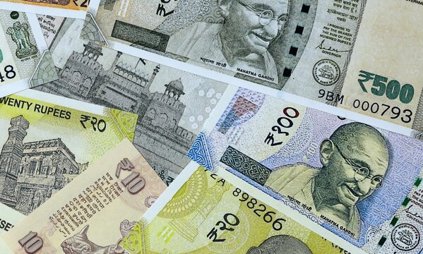 Indian rupee money bills in pile on table. India INR currency cash close up