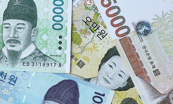 South Korean won money bills in pile on table. South Korea KRW currency cash close up