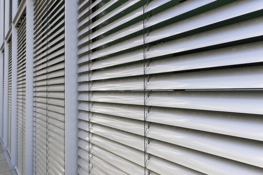 White exterior blinds on a modern building facade