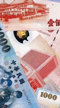 New Taiwan dollar money bills in pile on table. Taiwan TWD currency cash close up