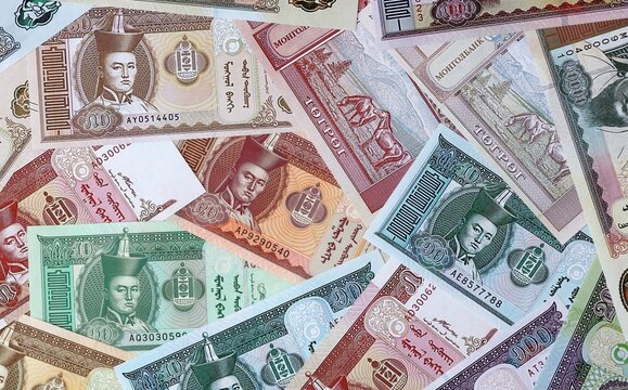 Mongolian tugrik money bills in pile. Big amount of Mongolia MNT currency cash close up