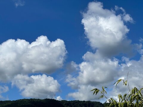 Dramatic White Clouds Over Green Hills Under Blue Sky in sylhet.
