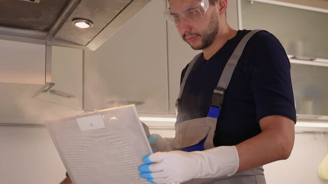 Professional technician ensures proper cleaning and safety measures. Trained technician performs detailed cleaning while maintaining safety in modern kitchen environment