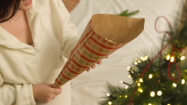 Warm holiday footage features a young boy who creates a festive game with ornaments and a toy vehicle. This candid family scene illustrates creative learning, screen free activity and togetherness.