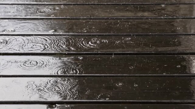 Rain falling on a wet wooden deck