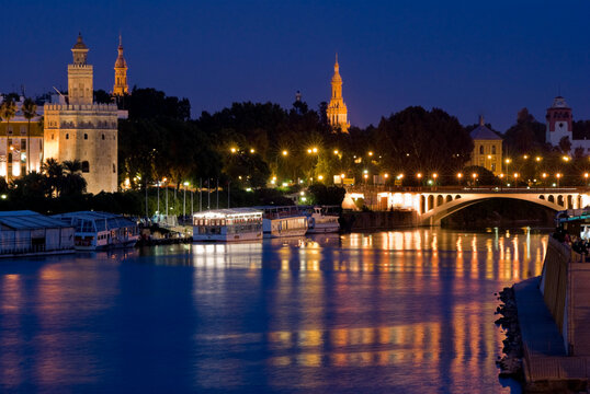 europe, spain, andalusia, seville rio Guadalquivir cityscape at dusk
