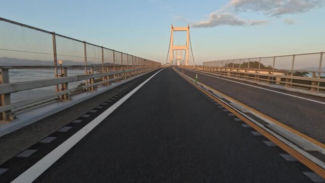 Approaching the tower of a long suspension bridge on two wheels