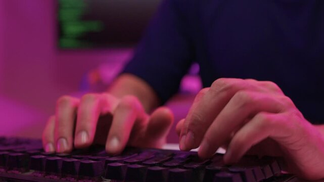 Focused coding session. Hands dash across keys with vibrant illumination. Intense keyboard action with RGB lighting highlighting dedicated programming night activities