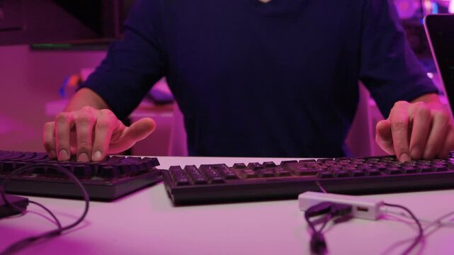 Focused coding session. Hands dash across keys with vibrant illumination. Intense keyboard action with RGB lighting highlighting dedicated programming night activities