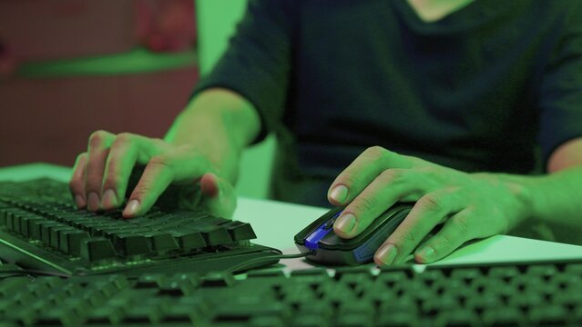 Focused coding session. Hands dash across keys with vibrant illumination. Intense keyboard action with RGB lighting highlighting dedicated programming night activities